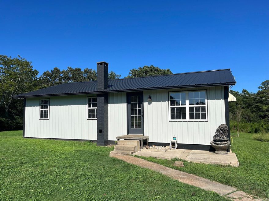 Conveniently located down the road from Mena Middle and High School, with a little bit of work, this adorable 3 bedroom 1 bath home would make a a perfect starter home, airbnb or fix and flip! The home sits on 2.5 acres, and provides the peace and quiet of country living and zoning, with in town convenience.   Previous owner has done many updates including some new double pane windows, R13 insulation throughout, OSB sheeting, a new roof, metal siding on front, and a brand new garage + studio space complete with a functional service panel. The interior has a renovated bathroom with soaker tub, some new cabinetry, drywall, a new kitchen faucet, electrical outlets and some updated fixtures. There is also a new refrigerator and on demand water heater.   This house will need a new full septic system installed, drywall mudding and paint, some additional windows.  Roll up your sleeves, and take this home to the next level!  This property is being sold AS IS.