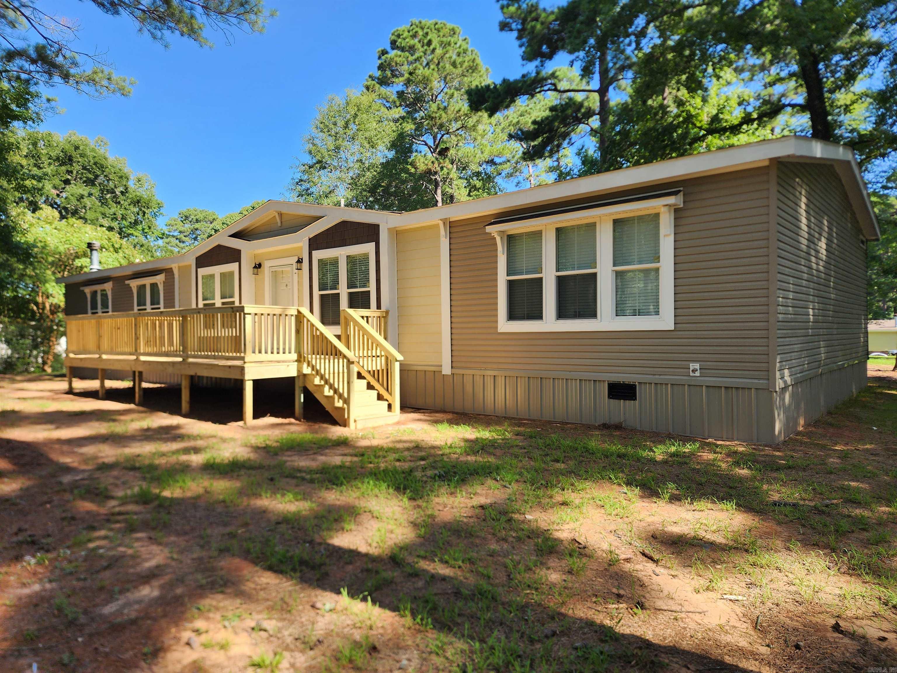 Spacious 2020 Sunshine mobile home situated on 1.5 acres, offering 2,400 square feet of comfortable living space. This 4-bedroom, 2-bathroom home features both a living room and a denāperfect for flexible living and entertaining. The cozy fireplace adds warmth and charm, while the front deck provides a great outdoor space to relax and enjoy the view. Listed at $210,000, this property offers room to spread out both inside and out.