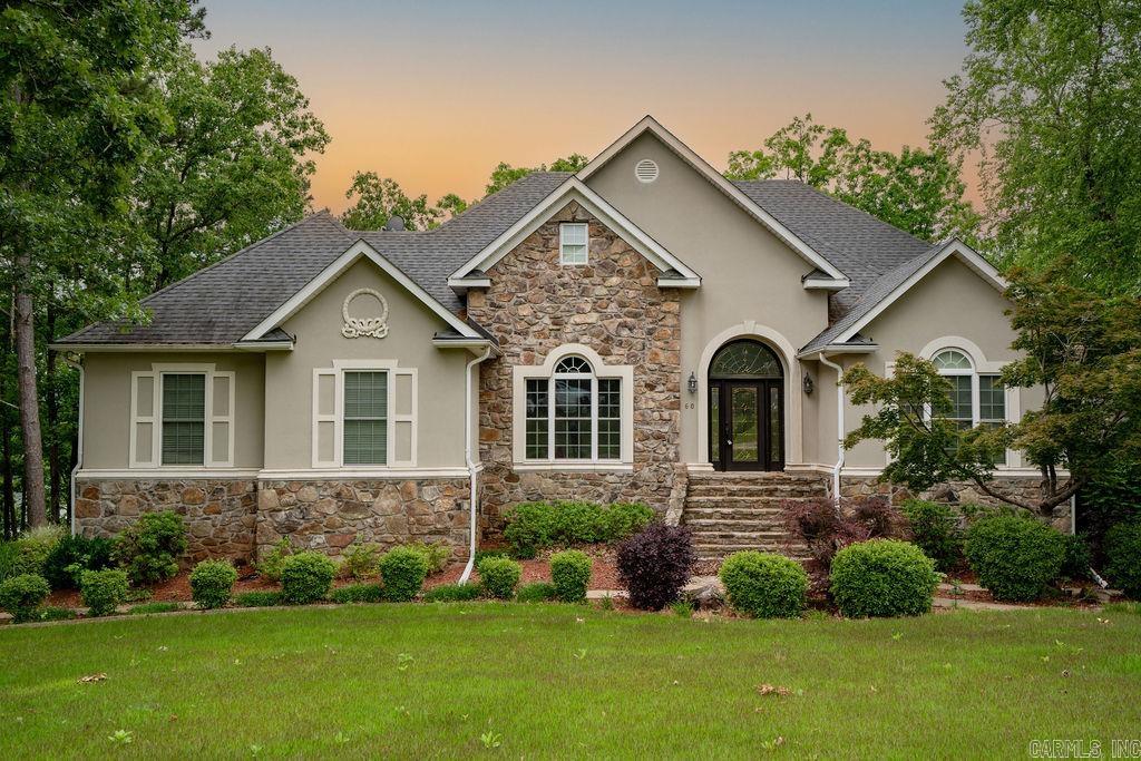 Stunning Lakefront Home in Hawks Pointe! This beautiful lakefront home sits at the point of Hawks Pointe Subdivision, offering a 180-degree water view. Enjoy a low-maintenance exterior, covered deck, and a manicured lawn with an extra lot. The main level features a Master Suite & second bedroom, while the lower level includes a third bedroom, safe room, bonus/game room, and wet bar. A rock path leads to the lake, perfect for enjoying the outdoors. Additional perks include a circle drive, attached two-car garage, and detached garage. New roof & resealed decks (2016). Don’t miss this rare lakefront retreat!