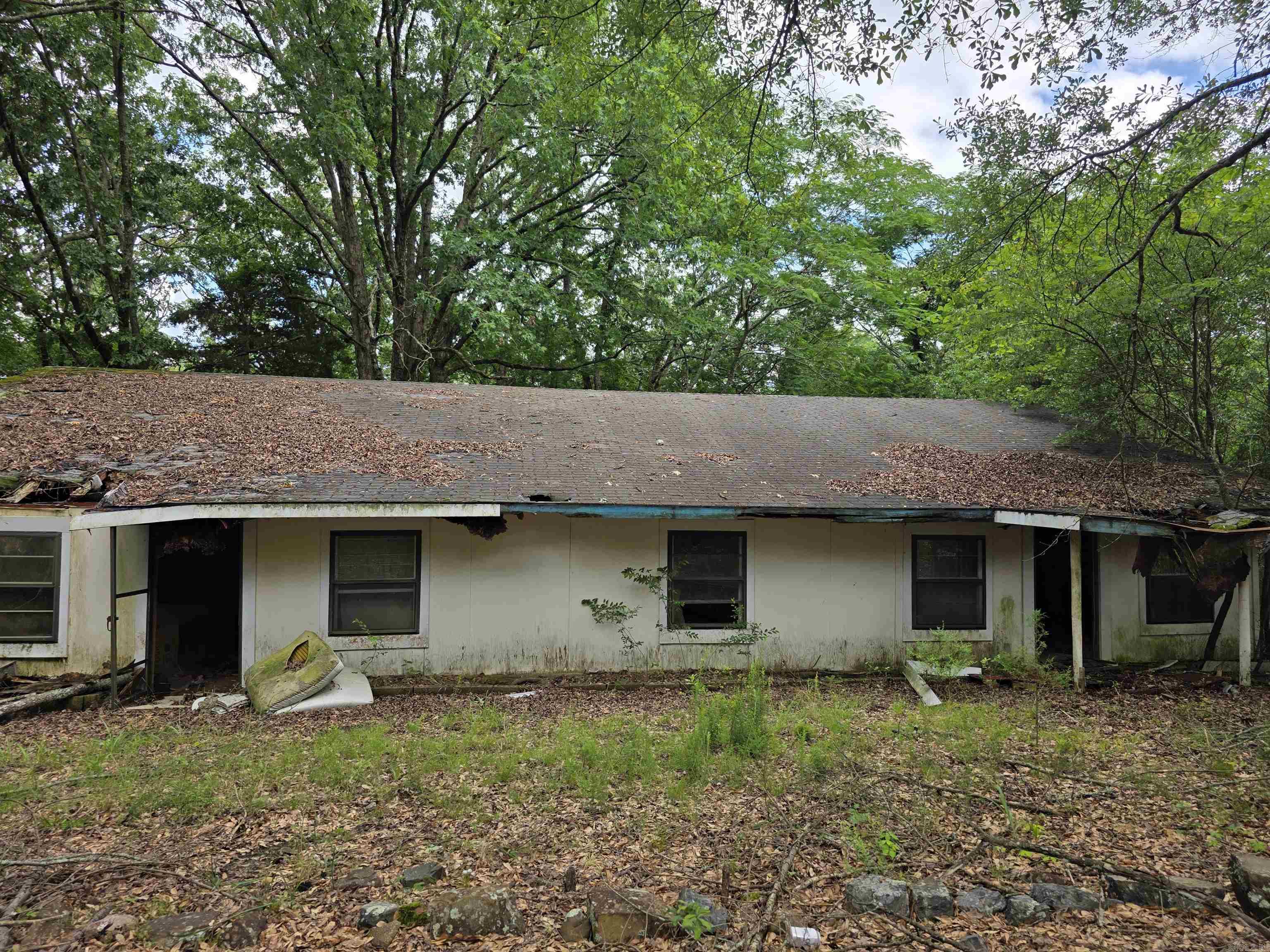 Older M/H of no value on 2.66 acres near Hatfield. DO NOT SHOW WITHOUT AGENT! Add-ons are falling apart, do not enter. Storage building and utilities on property. Circle driveway. Nice, wooded land