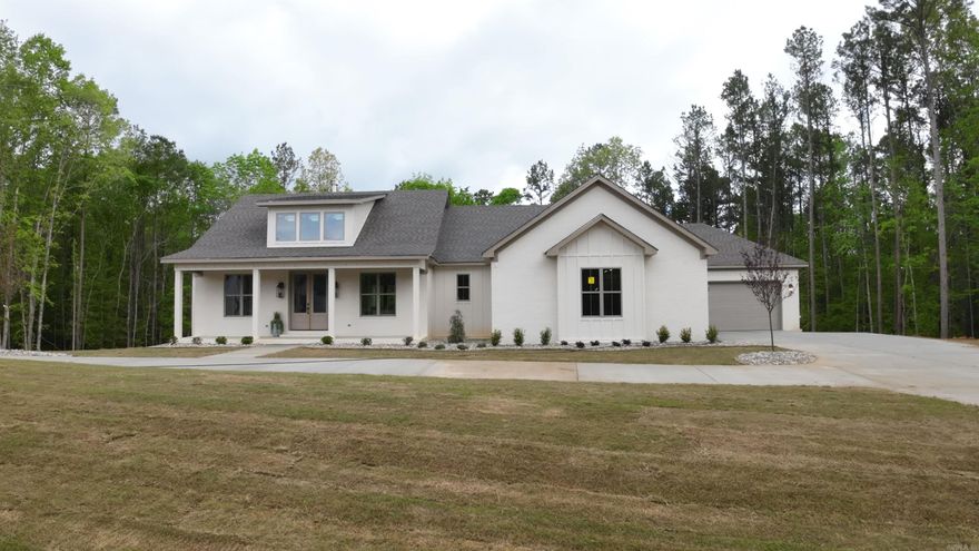 Introducing a stunning craftsman-style home nestled on 2.79 acres, offering exceptional privacy from the back porch with serene views of the surrounding woods. This spacious residence features four bedrooms and 3.5 baths, highlighted by exposed beams in both the living room and the master bedroom, adding character and charm.  The interior boasts laminate flooring throughout, with elegant tile in the bathrooms. The master suite includes a luxurious walk-in shower and a soaking tub, complemented by a huge walk-in closet that conveniently connects to a laundry room with ample storage.  The fourth bedroom features its own en suite bathroom, making it perfect for guests or family members. Downstairs, you'll find a great bonus room equipped with a half bath, perfect for entertaining or additional living space. The home also includes a four-car garage, with a mini-storage garage leading to the basement, providing excellent storage options.  This craftsman home seamlessly blends comfort, style, and practicality, making it an ideal retreat for those seeking a harmonious living experience.