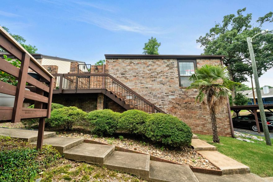 Discover your perfect retreat in the heart of Hot Springs! This beautifully updated two-bedroom, two-bath end-unit townhome offers modern comfort in a peaceful, green neighborhood. Enjoy single-level living with a bright, vaulted great room and new laminate plank flooring throughout. The kitchen features brand-new appliances. A spacious master suite offers a quiet escape with its own patio walkout. Step out onto the large deck overlooking lush green space—ideal for morning coffee or evening barbecues. Covered parking is just steps away, and you're minutes from hospitals, shopping, golf, dining, downtown, and three stunning lakes.