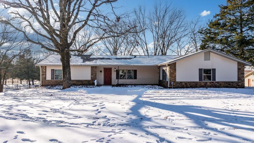 This property is a haven for horse enthusiasts, offering Bermuda pastures, an artisan well, a 125 x 60 foot covered riding arena with new performance foam footing, a six-stall barn with a feed room and wash stall, climate controlled tack room with half bath, pole barn, and spacious run-in sheds. A 2-car detached garage/shop and a shed provide additional storage. Step into a warm and inviting house adorned with wood and tile flooring. The great room features a vaulted ceiling and a wood-burning stove, creating a cozy ambiance. Newly remodeled bathrooms add a touch of modern luxury. The kitchen/dining combo is equipped with double ovens and an electric range. A large laundry room adds convenience to daily living.