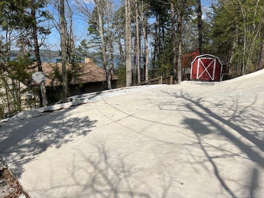 Nice lake house on Greers Ferry.  Walk down to lake from house.  2  bedrooms and 1 bath.   Lots of upgrades include concrete parking lot, new bathroom, updated flooring in kitchen, updated electrical and hot water heater.  Boat slip included in cove.  Great views of Lake - Fairfield Bay is across the lake, view of Sugar loaf mountain to the right, sunset to the left .  Great internet access.   Furniture included.