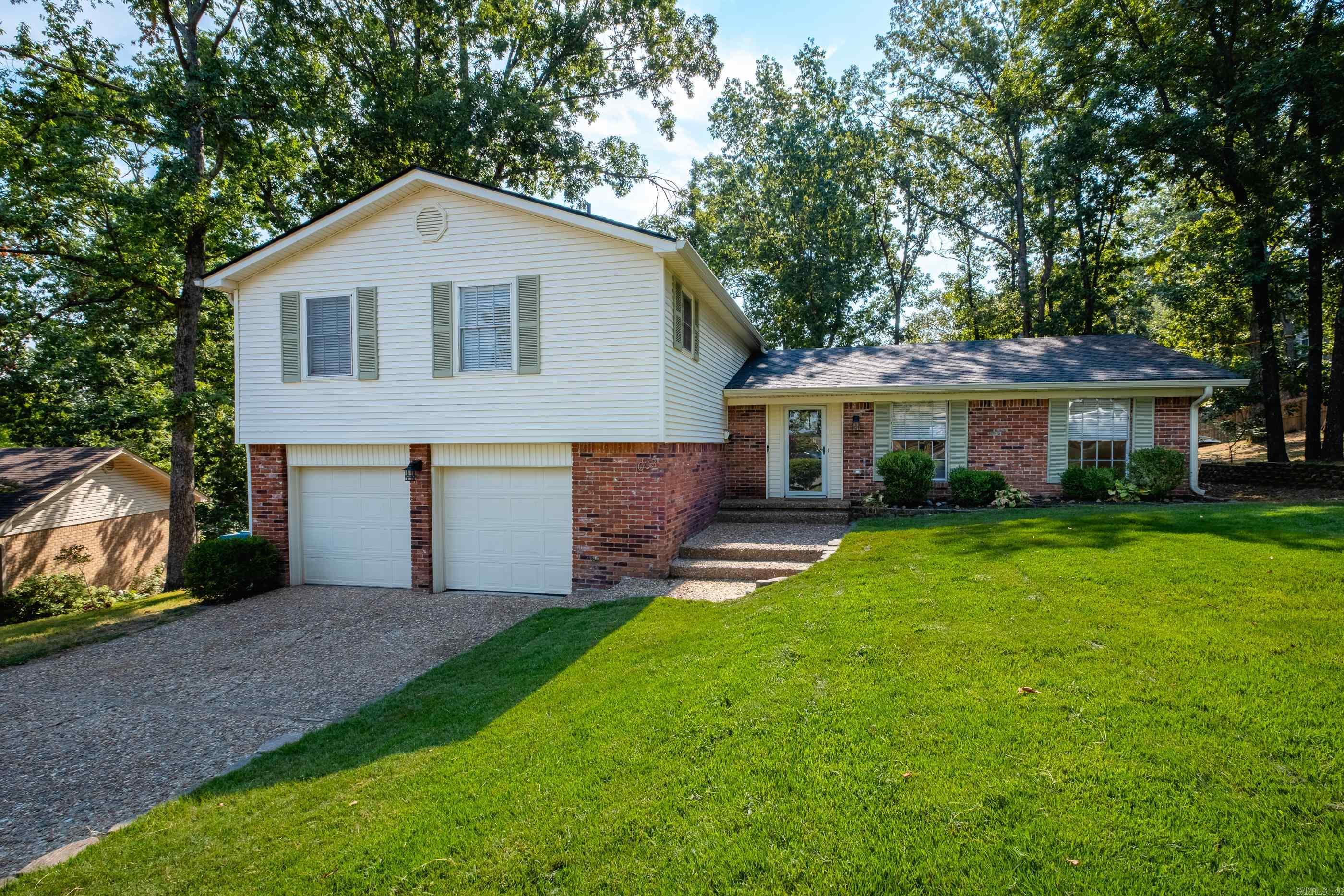 Beautifully updated WLR home on a quiet circle. This move-in ready home has been completely renovated from top to bottom in the last 2 years. Brand new flooring throughout includes wide luxury vinyl plank flooring downstairs, kitchen & living areas along with new carpet & tile upstairs. The kitchen shines with all new cabinets, countertops, fixtures & SS appliances, and also features a kitchen island w/ breakfast bar & spacious dining area with a custom bench. Upstairs you'll find a generous primary suite along with three additional bedrooms & second full bathroom. The lower level includes a large den/family room with fireplace, half bathroom & laundry room. Step outside to enjoy the large, fully fenced backyard from the deck/patio. Other major improvements/upgrades include new architectural shingle roof & 6" gutters (2023), HVAC - furnace & A/C (2022), and 50-gal. water heater (2024). A two-car garage and a short walk to the neighborhood park/pool make this home as convenient as it is charming.