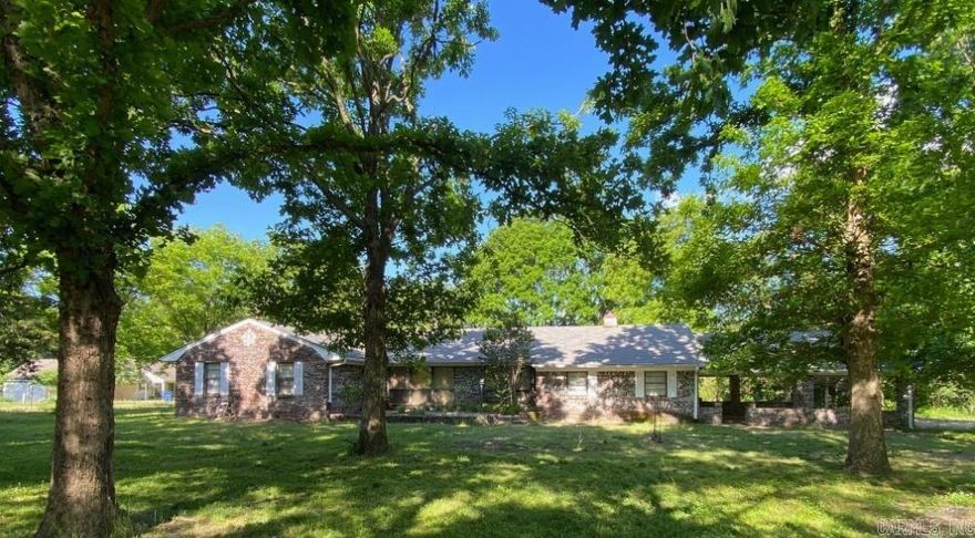 AUCTION DATE 5/18-5/21. This property has been placed in an upcoming event. All bids should be submitted at www.xome.com/auctions (void where prohibited). Please submit any pre-auction offer received through the property details page on Xome.com. Any post-auction offers will need to be submitted directly to the listing agent. All offers will be reviewed and responded to within 3 business days. All properties are subject to a 5% buyer's premium pursuant to the Auction Participation Agreement and Terms & Conditions (minimums will apply). Please contact listing agent for details and commission paid on this property. Embrace country living at its finest in this charming 3-bedroom, 2-bathroom home nestled on a sprawling 1.34-acre lot next to the river. Built in 1976, this 1824 square foot residence offers a blend of rustic appeal and modern potential, perfect for those seeking a peaceful retreat.  Step inside to discover a cozy living room with a fireplace, an inviting dining room, and a separate family room with a fireplace, kitchen, laundry room and lots of storage.   Earnest money required is 3% of the total purchase price or the minimum of $3000.00.  CASH ONLY, NO FINANCING.