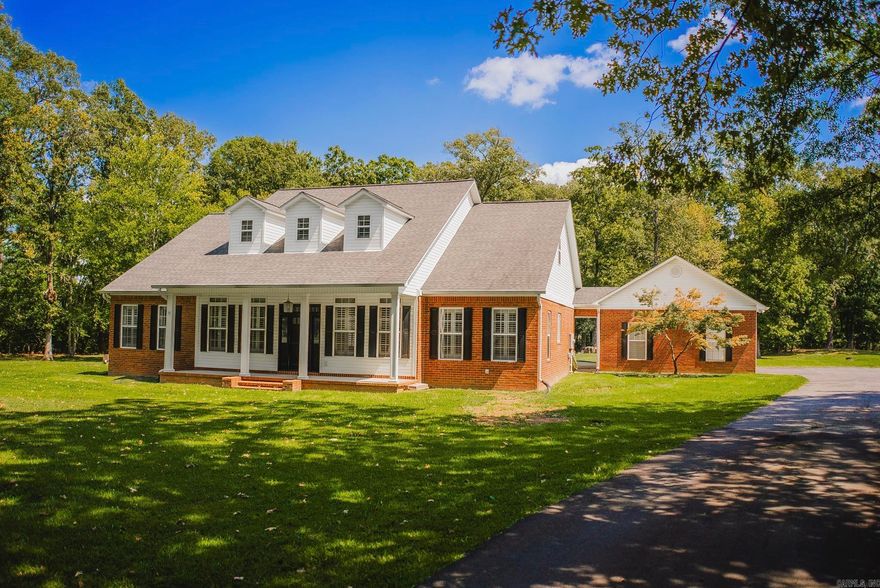Beautiful two-story traditional home on 3 wooded acres with mature shade trees, just minutes from town! This 4-bedroom, 4-bath home features the primary suite and an additional bedroom on the main level. The updated primary bath includes a freestanding tub for a relaxing retreat. Gorgeous wood floors flow throughout, and the office offers custom built-in bookshelves. Upstairs are two more bedrooms, two full baths, and a large bonus room ideal for a media or playroom. Enjoy the private backyard with a pool and attached potential pool house or mother-in-law quarters—already wired, walled and equipped with a mini-split, ready for finishing touches. A perfect blend of comfort, style, and outdoor living!