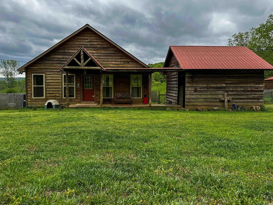 Take a look at this inviting 2 bedroom, 2 bathroom cabin offering 1,280 sq ft of easy, comfortable living in the heart of Mountain View, AR, with beautiful mountain views all around. Both bedrooms are spacious with nice closets, and one features a convenient pass-through style bathroom with access from both the bedroom and the hallway—perfect for guests while still giving a private feel. Inside you’ll also find a cozy upstairs loft, a great pantry, and plenty of storage throughout. Sit back and unwind on the welcoming porches, or enjoy the practicality of the enclosed carport and breezeway. Outside, the property is ready for a little country living with a fenced area for animals, a garden spot, and a peaceful wet weather creek. There’s also a detached workshop/garage for tools, toys, or hobbies. With city water, septic, and partial fencing already in place, it’s set up and ready to go. Tucked less than half a mile down a gravel road, you’ll have the privacy you want without being far from town—just minutes from the White River, the Court Square, and Ozark Folk Center State Park, with Blanchard Springs Caverns only a short drive away. Priced at $214,999