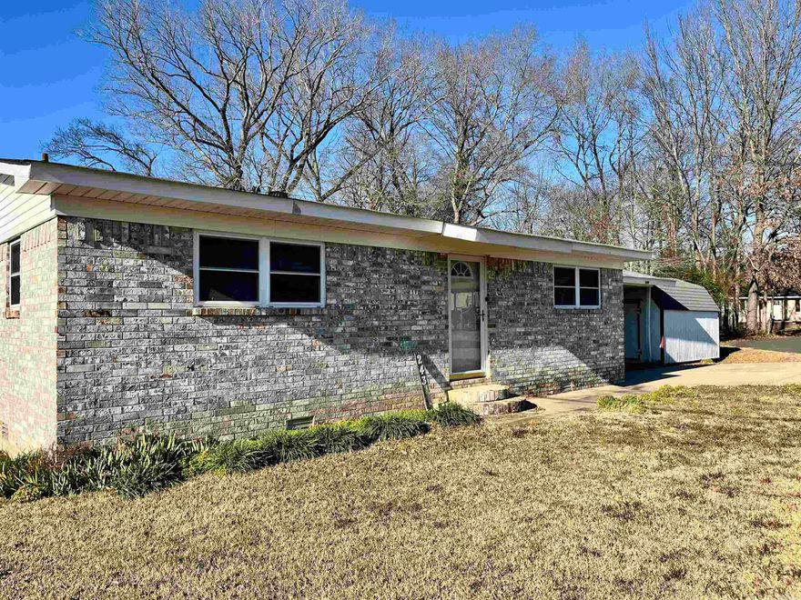 Welcome to 243 Elmwood Dr in Hot Springs, AR, a conveniently located corner-lot property offering a functional layout and comfortable living spaces. Inside, the home provides a functional layout designed for everyday living. Primary bedroom has a half bath with a closet that can be used for clothes and/or storm shelter! Outside, enjoy a deck ideal for relaxing or entertaining, along with a detached shed that offers additional storage or workspace options. The property sits on a manageable lot, allowing for easy maintenance while still providing usable outdoor space. You even get a glimpse of the lake in the front yard! Its location offers quick access to shopping, dining, medical facilities, and other local amenities, making daily errands and commuting convenient. Agents see remarks!!