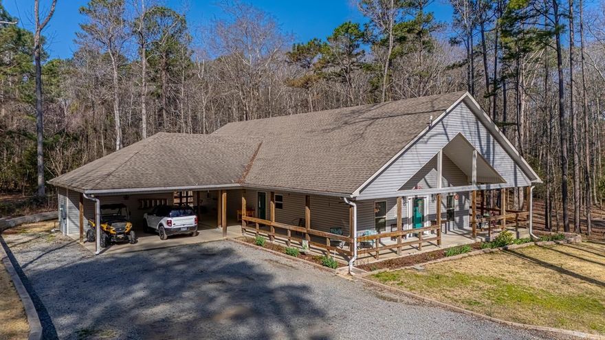 This charming 2-bedroom, 2-bath home sits on over 3 acres of picturesque land, offering both privacy and plenty of space for outdoor activities. A standout feature is the expansive wrap-around porch, providing a perfect setting for relaxing and enjoying the serene surroundings. The porch invites you to take in views of lush greenery and thoughtfully added landscaping, creating a welcoming atmosphere as you approach the home.  Inside, the open-concept living areas are bright and airy, with the kitchen, dining, and living spaces designed to flow seamlessly together, making it ideal for both everyday living and entertaining. The home’s two spacious bedrooms offer comfort, while the two bathrooms provide modern finishes and ample space.  A versatile bonus room adds further value to the home, offering the potential to be used as a third bedroom, office, or playroom to suit your needs. There’s also plenty of additional storage throughout the home, along with a separate storage area on the property, perfect for keeping outdoor tools or equipment. This property is also equipped with a reliable generator, ensuring peace of mind during power outages.