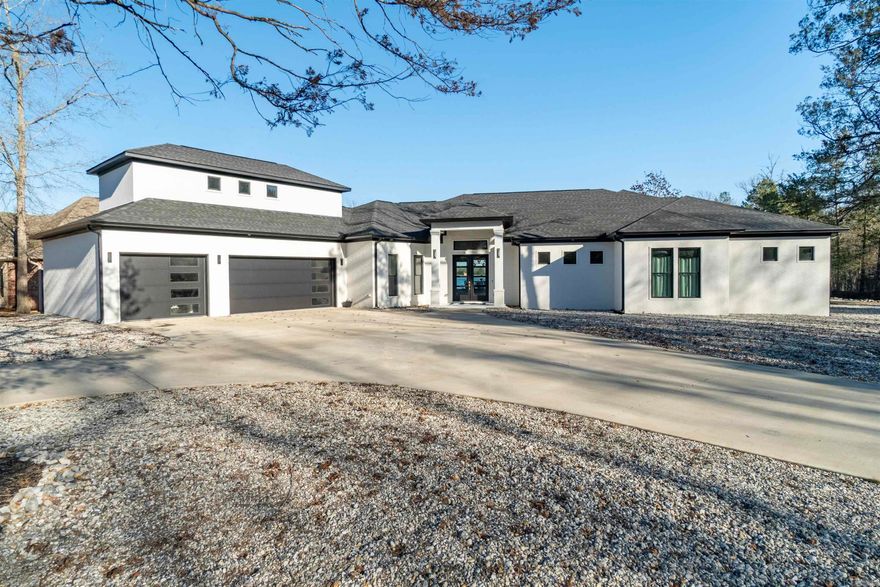 So you are planning to retire this year, come to Hot Springs Village & build the house of your dreams on a beautiful flat lake lot. Guess what? It has been built giving you a view of the huge lake view. What could be better? Open plan has divided bedrooms. Kitchen is chef's delight - abundance of custom cabinets, and upgrades everywhere (more than you might have ever thought available) - custom finishes everywhere! HUGE windows, & volume ceilings, linear electric fireplace, 3 car oversize garage, circular drive, huge finished suite above 3rd car garage - you name the use. Sprinkler system in back yard. You could not have done better if you could have found a flat half acre lake lot. List of amenities in " Documents" Agents please see confidential remarks.