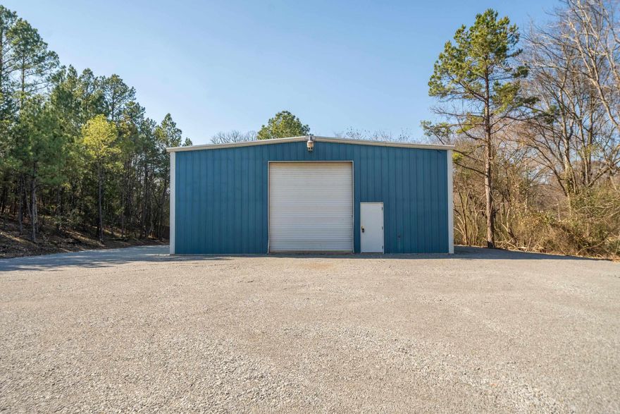 Check out this move in ready commercial building with unlimited potential to make it your own. All new LED lighting, new bathroom, rustic knotty pine wood, 4" rolled SB2 huge parking lot, new entry drive and complete access and parking around the building as well as new heating. All roof screws have been replaced.  Equipped with three -220v welder plugs.  This 60x40 shop building with a 40-foot clear span and 16-foot eave height, providing substantial space for various commercial uses, from light industrial operations to warehousing and service-based businesses while the expansive lot offers room for future development, parking, or outdoor storage options.  Situated in a prime, high-traffic location it's ideal for entrepreneurs and investors alike, this property is strategically positioned for Hot Springs' growing commercial market, offering income opportunities through potential leasing or expansion.