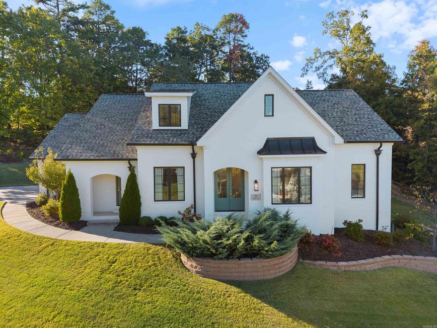 Beautifully maintained 4-year-old home in the sought-after Chenal Valley "Challain Place" just a short walk to the neighborhood pool, park, and basketball courts. Classic painted brick exterior with black accents offers timeless curb appeal. Custom double front doors lead to a bright, open floor plan with 11-ft ceilings, luxury vinyl plank flooring, and large windows. The kitchen features quartz countertops, stainless appliances (gas range, vent hood, microwave, dishwasher, refrigerator), pot filler, pantry, and a large island with bar stool seating. The great room includes an electric LED fireplace and access to a covered back porch. Open concept floor plan with dining room and sitting area (could be used as breakfast area if desired). The private primary suite includes a recessed ceiling, spa-like bath with soaking tub, walk-in shower, dual vanities, private water closet, and walk-in closet. Also on the main level is a guest bedroom (or office) with full bathroom, laundry room with sink, and a 3-car side-loading garage. Upstairs: cozy den with office nook, 2 bedrooms, and full bath. Includes surround sound, sprinkler, 6" gutters, drainage system, and completed pre-inspection.