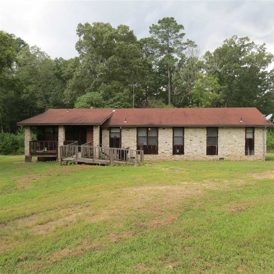 Country living at it's best.  This home is built of beautiful stone on the front of the home, on 14 acres in Cleveland County.  Separate floor plan, open living and dining area.  Enclosed garage.  This home comes with refrigerator, washer and dryer.  Timber has been cruised and is valued at approximately $21,000. in pine and hardwood. Call today for your personal tour.