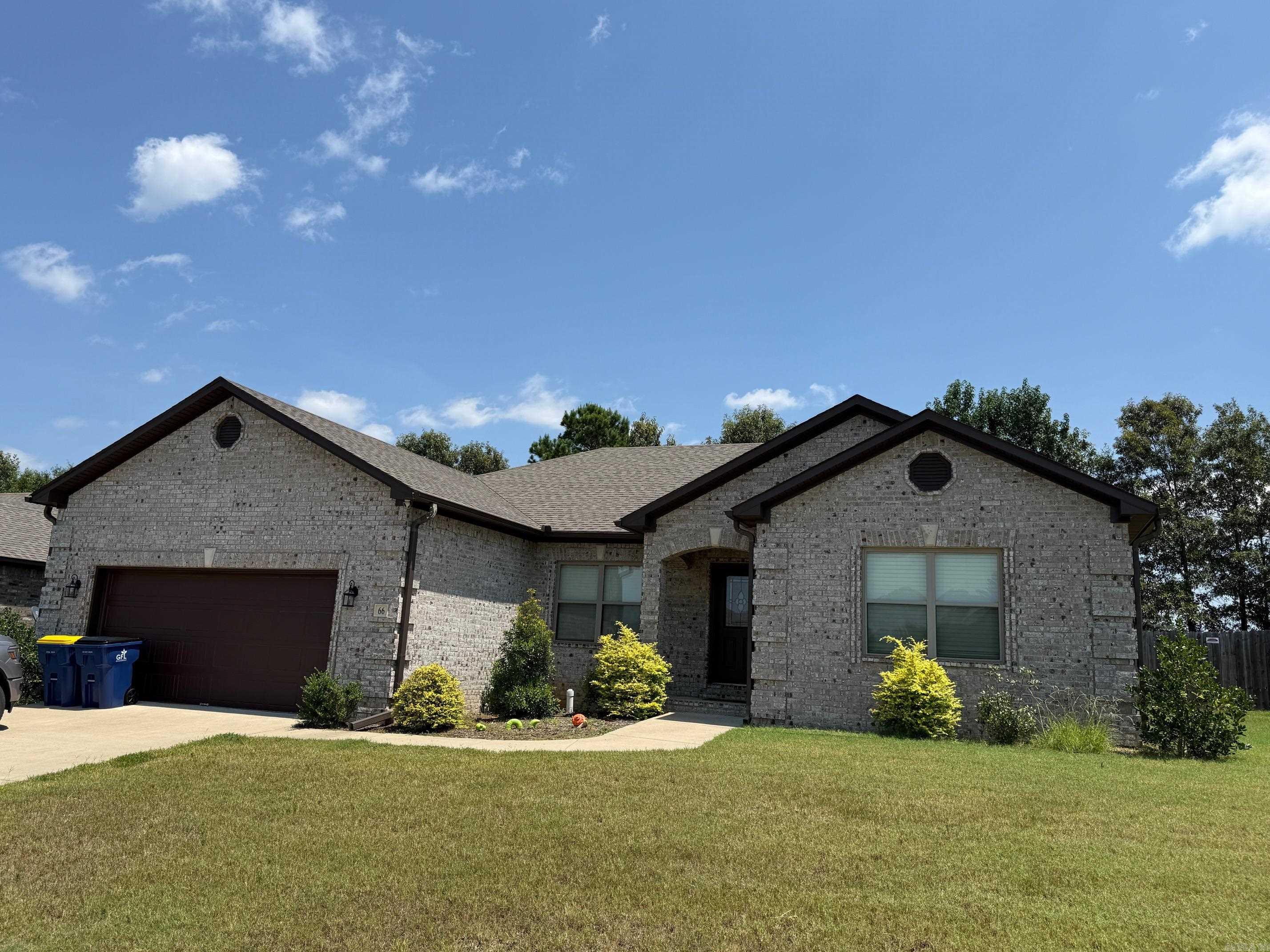 Experience comfort and style at 66 Cimarron Circle! This beautiful 4-bedroom, 2-bath home boasts a thoughtfully designed split floor plan that offers privacy and functionality. The spacious primary suite features a luxurious bath complete with a separate soaking tub and shower, double sink granite vanity, and an oversized walk-in closet. Step into the heart of the home—an open-concept living, dining, and kitchen area filled with natural light, an electric fireplace and sweeping views from every window. The kitchen is a chef’s dream, showcasing stainless steel appliances, a large island, granite countertops, tile backsplash, a huge walk-in pantry, and under-cabinet lighting for added elegance. Each secondary bedroom includes ceiling fans and ample closet space. Step outside and unwind on the oversized covered porch—perfect for enjoying peaceful evenings or entertaining guests. This home blends beautiful details with everyday function—ready to welcome you home!