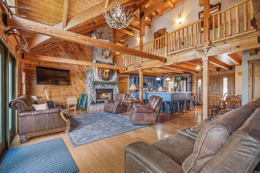 One of a kind lakefront log cabin! This 5 bed, 5 bath home offers a rare combination of space, character, and lakefront living with 82 feet of lake frontage on Lake Hamilton. Every bedroom has its own en suite, providing comfort and privacy for family or guests. The main level features. two primary suites, while upstairs offers tow additional bedrooms with private baths. The lower level includes a second living area with a pool table, plus another bedroom and bath--perfect for entertaining or multi-family use.   Vaulted ceilings, spacious rooms, and warm log-cabin charm create a cozy yet grand atmosphere. Step out onto the back porch to take in gorgeous lake views. Selling fully furnished, this home is currently operating as a licensed short-term rental, with the license transferable to the new owner. Ideal as a primary residence, vacation home, or income producing property.