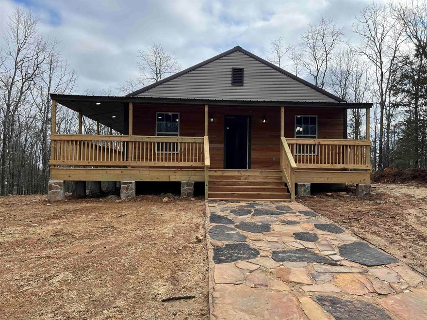 Brand New Construction rural charmer with wrap around porch sitting on 1 acre. Property is about a 25 minute drive from Cabot, Conway, Jacksonville, and Sherwood. 2 bed 2 bath with lvp floors in living areas and bedrooms. Tile in bathrooms. Butcher block style kitchen counters, electric cooktop stove, dishwasher, over the range mw.  Tankless water heater, washer & dryer connections, All electric, 36k btu min-split hvac, city sewer with septic tank. Blown in insulation in attic, polyurethane foam insulation in crawlspace. 28'x36' house with 6' wrap around porch on half the house. Metal roof.  Peace and tranquility waiting for you in the woods! This one won't last long.  Agents, see remarks