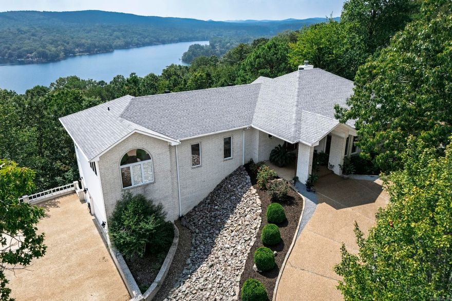 Stunning mountain vista home with amazing views of the Ouachita Mountains in beautiful Hot Springs Village. The vaulted living room ceiling, featuring large glass windows, provides panoramic mountain views. The circular driveway invites you into this stately and well-maintained home. Two master bedroom suites on the main level and two bedrooms on the lower level afford ample room for family and guests.  Dishwasher, sink, and disposal 2023. Rebuilt composite deck 2022. Roof 2019. Maini level HVAC 2023, lower level HVAC 2022. Hot Springs Village has a one-time buy-in fee of $2,000 paid at closing.