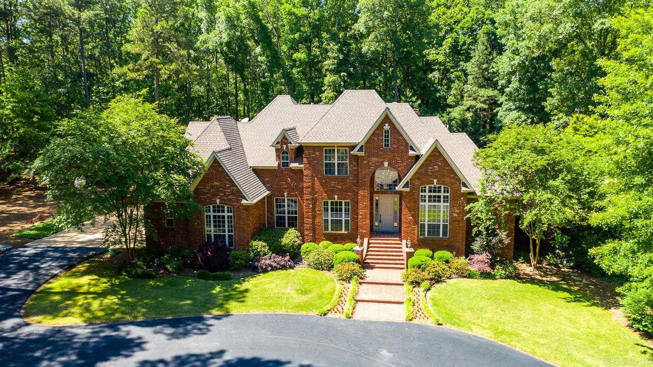 As you drive through Windsong Estates to 245 Windsong Drive, you are instantly entranced by the mature trees, foliage, and stunning estates that give the feeling of opulence! Entering the circle driveway you are met with the stately curb appeal right away! As you enter the front door, your eyes are drawn upward to the 18 foot ceiling and elegant finishes. Two living spaces serve families well, both for entertaining and casual enjoyment. The kitchen opens to the living room and features NEW granite counter tops and large undermount sink. Upstairs you will find four additional bedrooms one with a private ensuite, another with a hidden space, and ample storage throughout. The exterior of the home is something straight out of a magazine with specialized lighting accentuating the stunning water feature and landscaping, the newly added seamless addition of a stamped concrete outdoor kitchen with granite counter tops and spaces for extra large egg cookers, and the circular fire pit with area for seating! Don't forget to tour the new on-site built shed with additional attic space! Agents, please see confidential remarks.