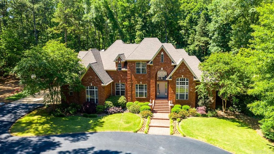 As you drive through Windsong Estates to 245 Windsong Drive, you are instantly entranced by the mature trees, foliage, and stunning estates that give the feeling of opulence! Entering the circle driveway you are met with the stately curb appeal right away! As you enter the front door, your eyes are drawn upward to the 18 foot ceiling and elegant finishes. Two living spaces serve families well, both for entertaining and casual enjoyment. The kitchen opens to the living room and features NEW granite counter tops and large undermount sink. Upstairs you will find four additional bedrooms one with a private ensuite, another with a hidden space, and ample storage throughout. The exterior of the home is something straight out of a magazine with specialized lighting accentuating the stunning water feature and landscaping, the newly added seamless addition of a stamped concrete outdoor kitchen with granite counter tops and spaces for extra large egg cookers, and the circular fire pit with area for seating! Don't forget to tour the new on-site built shed with additional attic space! Agents, please see confidential remarks.