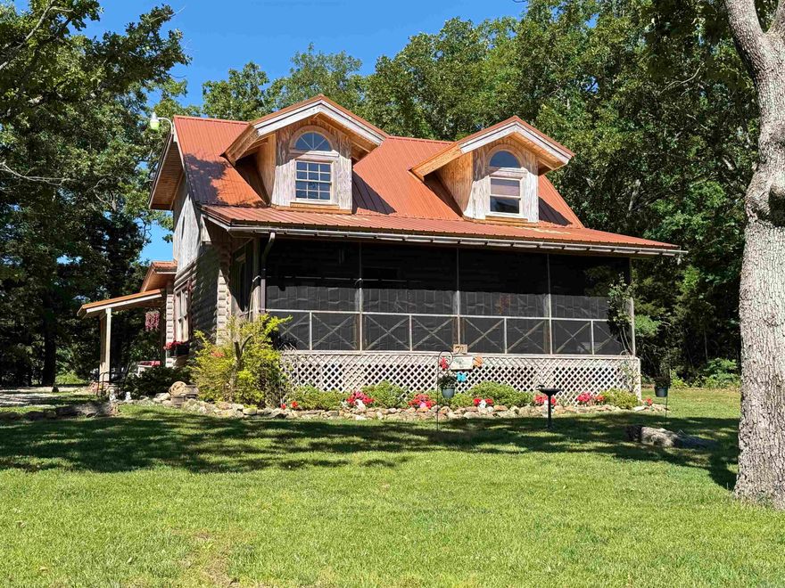 Discover the perfect blend of rustic charm and modern comfort in this beautifully crafted log home, nestled on 20 private acres in the rolling hills of Sharp County. Hand-hewn log construction, gleaming bamboo hardwood floors, and a fully updated kitchen with newer stainless steel appliances create a warm, inviting interior. The main level features two spacious bedrooms and two full bathrooms with attractive tile flooring. A large loft with its own closet offers flexible use as a third bedroom, office, or creative space. The property is ideal for hobby farming or homesteading, with fencing, fruit trees, and multiple outbuildings ready for animals, equipment, or workshop needs. A new septic system, French drains, storm shelter and a striking bronze metal roof provide long-term peace of mind. Enjoy a mix of wooded acreage—perfect for hunting, hiking, and privacy—and open pastureland ready for livestock or expansion. This is true Ozark living: quiet, scenic, and full ofpossibility.