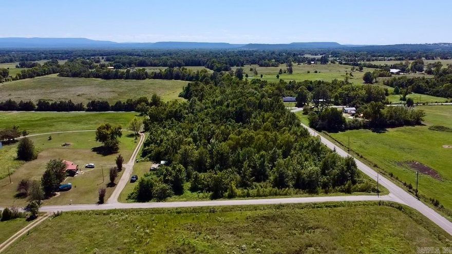 Located in the AR River Valley in Wine Country this heavily wooded tract offers the opportunity to be completely surrounded by mature trees and no visible neighbors.  Surround on all 4 sides by country roads.  Utilities should be easily accessible.  Electric (OGE) on site.  Small pond centers property.  No known restrictions.  If you love the outdoors this property is minutes from the AR River to the south and 10 minutes from all the local wineries!!  Hope on the ATV and the outdoor adventure begins.