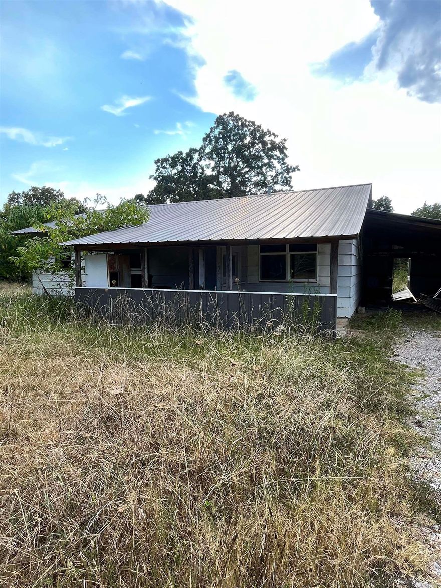Partially Remodeled Fixer Upper with Highway Frontage-selling AS IS  Sitting on 1.10 acres with valuable highway frontage, this property offers both convenience and potential! The home has already received key updates, including new windows, doors, drywall, and HVAC.  Featuring a frame-enclosed back porch, a screened front porch, and a carport, this home provides a solid start for someone ready to finish it out with their own personal touch. Whether you’re looking for a residential project or an investment opportunity, this property is full of possibilities! *utilitites not on at this property. selling as is, where is