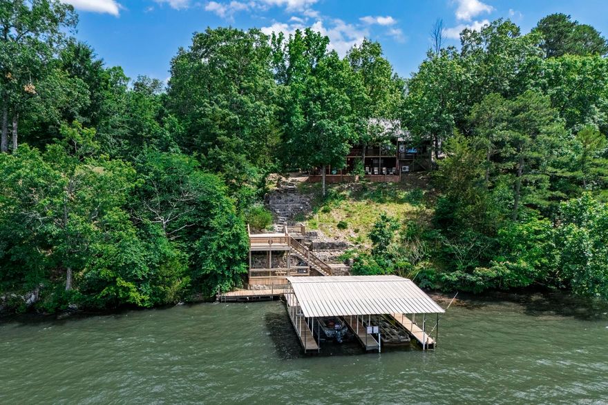 Welcome to your dream home on Lake Hamilton, where modern elegance meets serene lakefront living. This beautifully remodeled three-bedroom, two-bathroom residence, updated in 2018, boasts a brand new metal roof and a spacious primary suite that offers breathtaking views of the lake, complete with an oversized shower and a luxurious soaking tub. The home features a generous multi-level back deck, perfect for entertaining or simply enjoying the stunning surroundings, leading down to a private boat dock. Complementing the property is a massive three-bay shop, providing ample space for hobbies and storage. The entire property is fully fenced, ensuring privacy and security while enhancing the beauty of this absolutely stunning lakeside retreat. Experience the perfect blend of comfort, style, and outdoor adventure in this exceptional home.