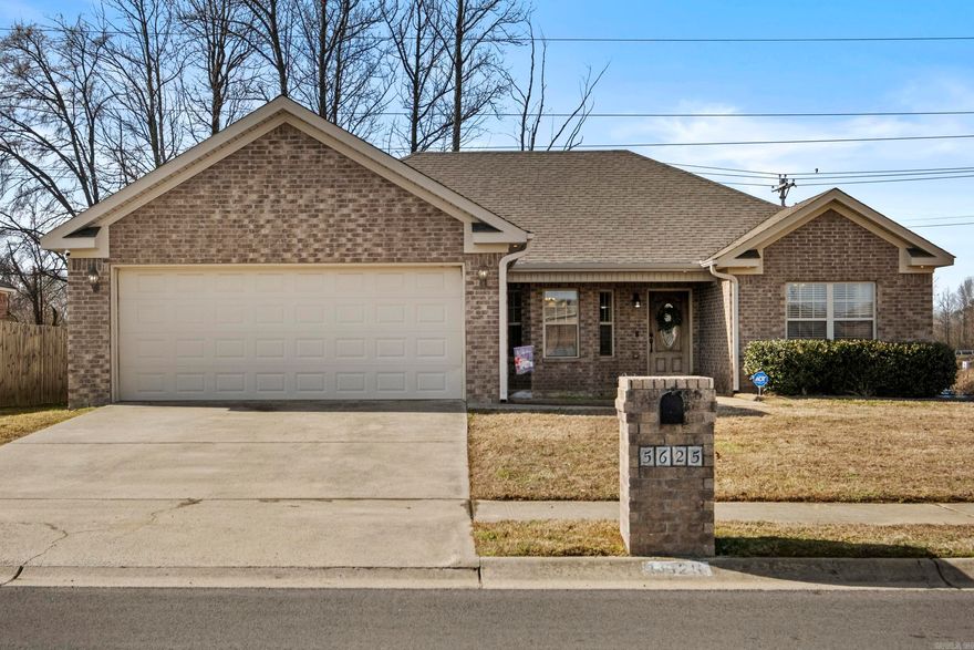 Don't miss this super cute home on a level, corner lot, with a private backyard! Upon entry, you will note the pretty wood floors that flow seamlessly into the cozy living room. Anchored by a fireplace that is complete with gas logs, this living space boasts lots of natural light! Step into the eat in kitchen where you will see pretty white cabinetry with granite countertops and glass tile backsplash. The microwave was new in 2025 and the stainless steel refrigerator will convey to the new buyer. The primary suite features a tray ceiling and an ensuite bathroom complete with double sinks, tub shower combo, linen closet and double closets. On the other side of the home are two spacious guest rooms that share a hall bath. On the exterior, the sellers added gutters in 2025 and backyard is fully fenced. Agents, see remarks.