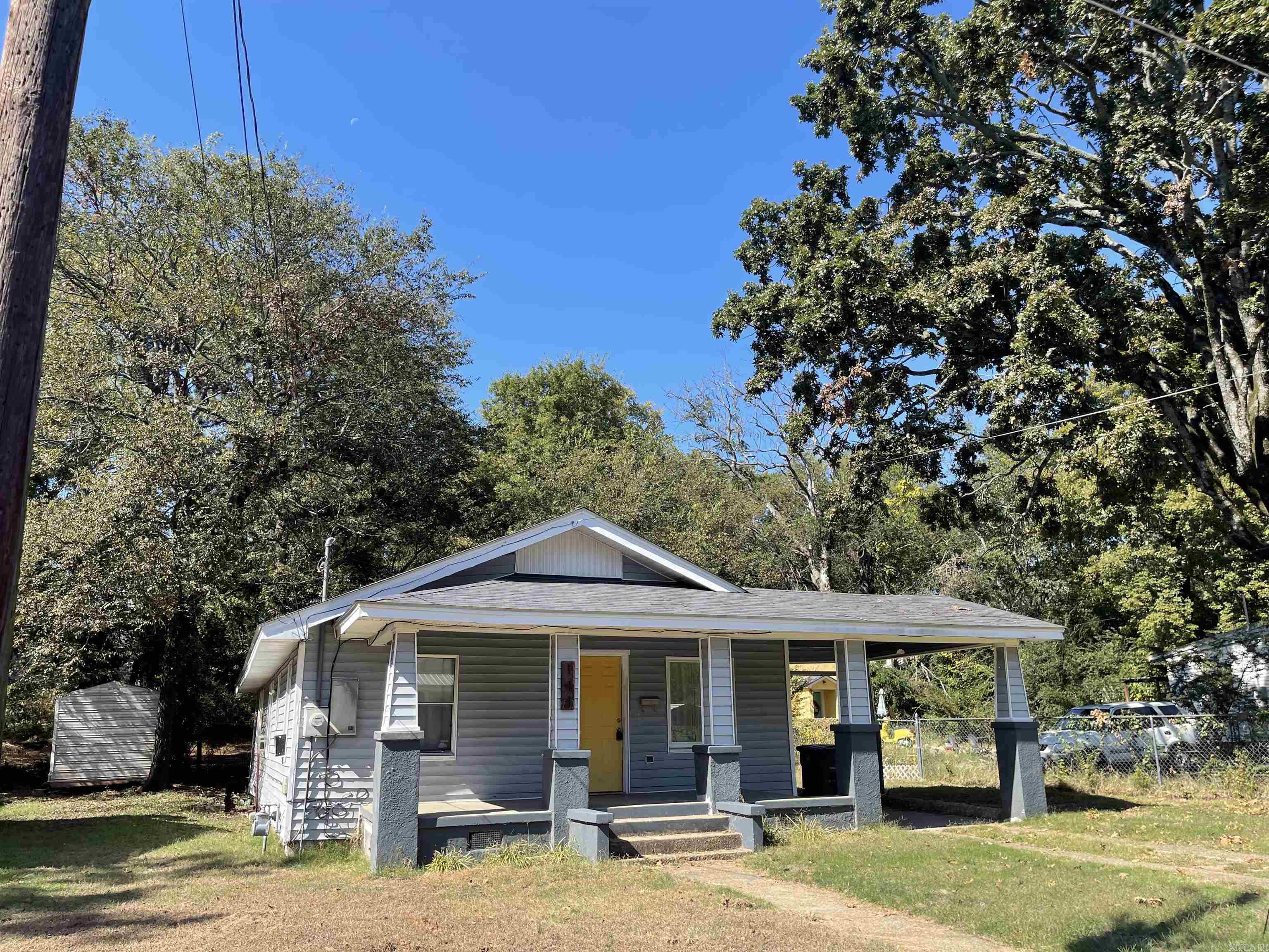 Great home in convenient location to shopping. This 3 bedroom home still has the original hardwood floors through most of the house. Kitchen, bath and laundry room have vinyl floors (hardwood may be present underneath). Large kitchen with Original Built-in's and Hardwood doors, adds to that Vintage feel. Back bedroom is large. Walk-in laundry room. Nice back yard, partially fenced. One car Carport and nice front porch.