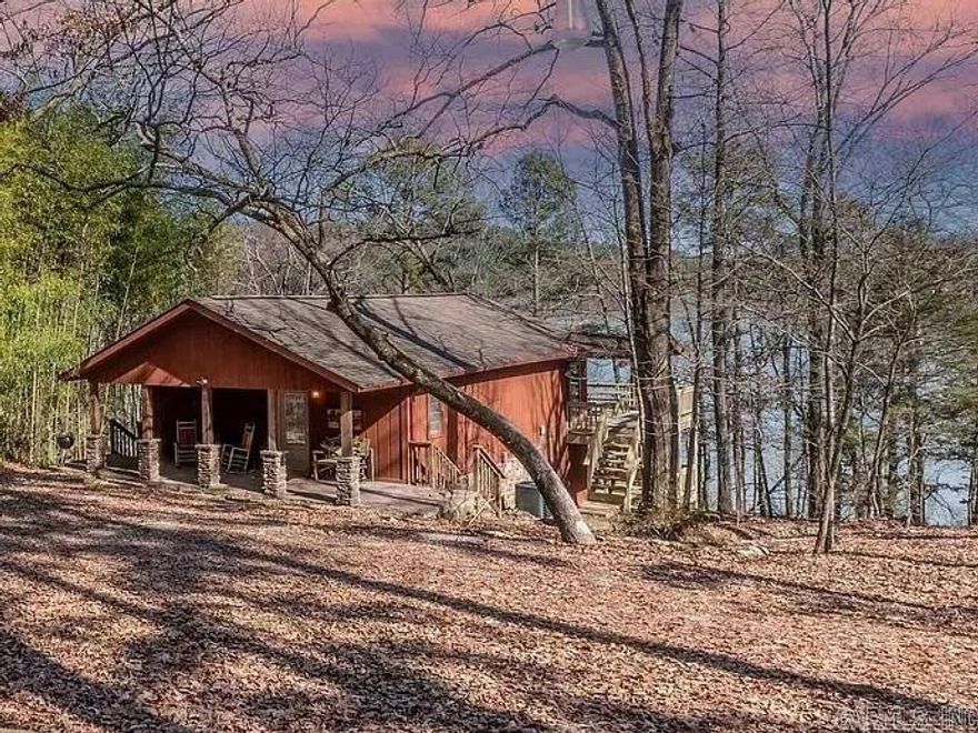 Nestled on a secluded, wooded lot in Harper’s Cove, this three-bedroom, one-and-a-half-bath cabin is an updated retreat designed for easy lake living. The interior features an open-concept living, dining, and kitchen area built for entertaining, alongside an additional reading nook for quiet downtime. The large master bedroom serves as a private escape, offering beautiful sunrise views over the water. Equipped with modern connectivity and high-speed fiber, the home remains as functional as it is peaceful. Outside, an expansive double deck provides panoramic views and clear path to the shoreline for swimming, fishing, and boating. A convenient boat launch is located less than half a mile away for easy lake access. The property has a proven history as a short-term rental but also serves as a cherished family retreat. This home offers a rare opportunity to own a piece of paradise in a premier cove location.
