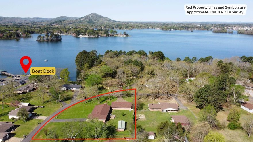 Welcome to your dream lake view retreat! This beautiful 2,752 sq. ft. home, nestled on nearly an acre right off Lake Hamilton, offers the perfect blend of luxury, space, and privacy. Whether you're looking for a peaceful getaway or the ultimate entertainment space, this home delivers!  4 Bedrooms | 2 Baths | 2-Car Garage + 3-Car Garage/Shop   Unbeatable Lakeview Living: Enjoy stunning lake views from your expansive front porch or take advantage the boat ramp—ideal for lake lovers!  Spacious & Stylish Interior: Featuring hardwood & tile flooring throughout, a generous dining area, and an open-concept kitchen complete with a fridge that conveys.  Primary Suite Retreat: Designed for comfort with double sinks and a walk-in tile shower for a spa-like feel.  Ultimate Storage & Functionality: A large detached 3-car garage/shop provides plenty of room for vehicles, watercraft, or a workspace, plus a greenhouse in the backyard for gardening enthusiasts.  Convenience & Comfort: The spacious laundry room includes extra counter space, making everyday tasks a breeze.  This brick & siding home is a rare find, offering both tranquility and easy access to the water! Schedule a tour today!