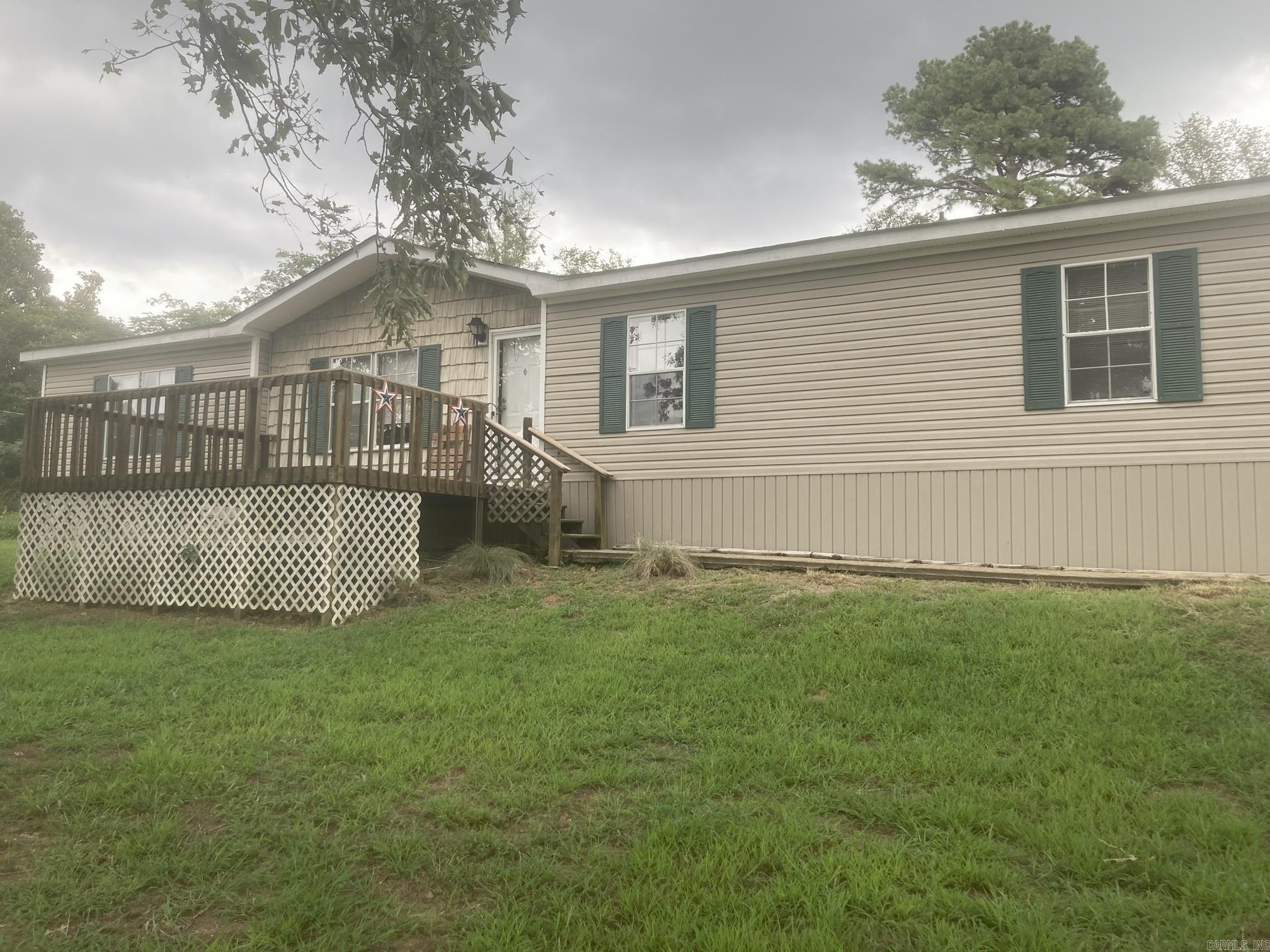 Enjoy beautiful views from the front deck. This spacious open concept home has two living areas, a large kitchen, a wood-burning fireplace and a split floor plan. There is a deck on the back. Roof was replaced 5 years ago. Large partially fenced yard on almost .5 acres of land.