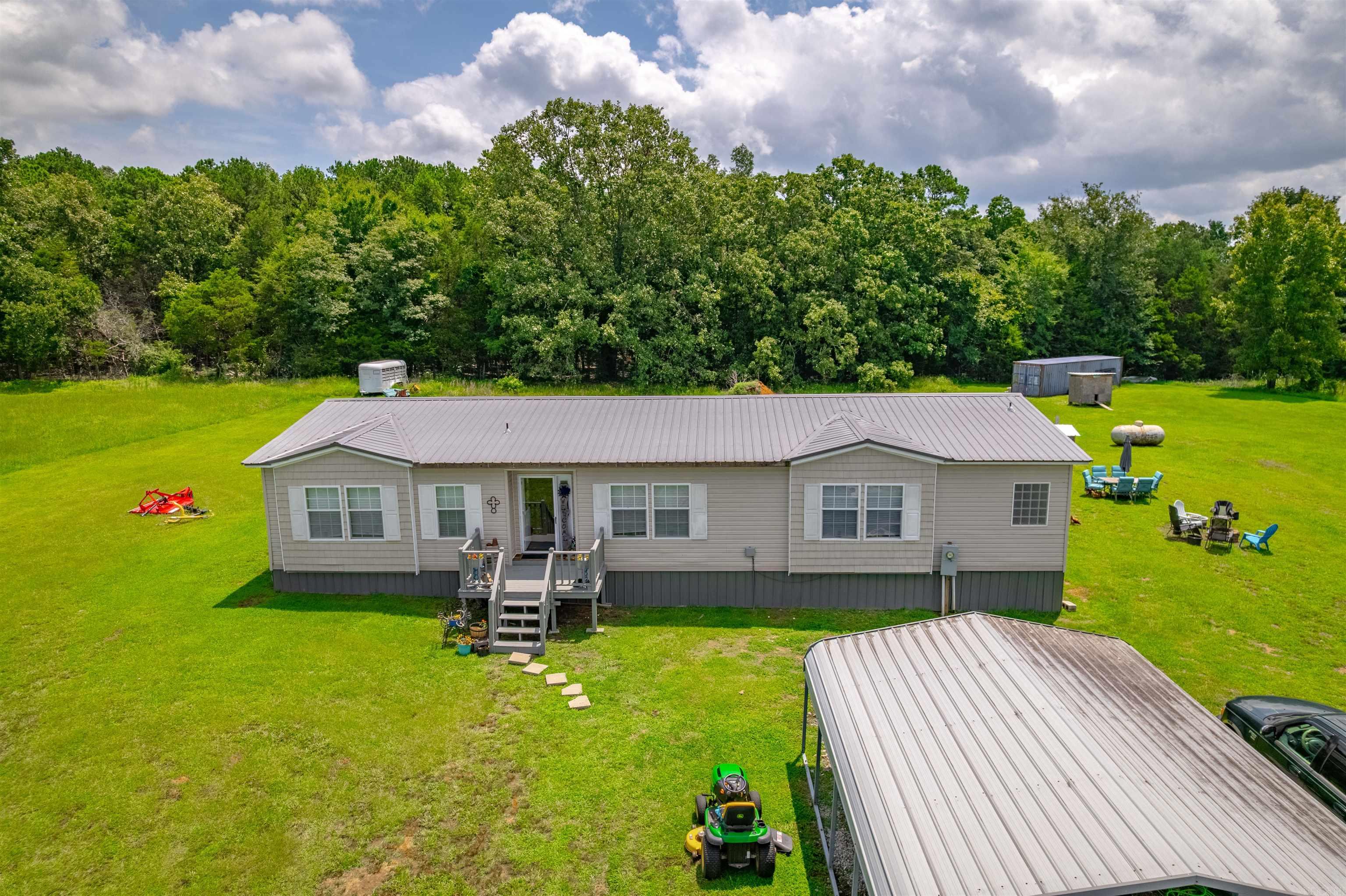 This unique property, located in Greers Ferry, AR, encompasses 47.84 acres and features three ponds, two of which are stocked with fish. The grounds also include two spacious shop buildings measuring 80x100 and 40x50, as well as a new above-ground pool adjacent to the residence. The home offers three bedrooms and two full bathrooms, with updated flooring, paint, and trim completed in August 2024. The entire property is fully fenced and equipped with fiber internet connectivity. To schedule a viewing or request further information, please contact us at your convenience.