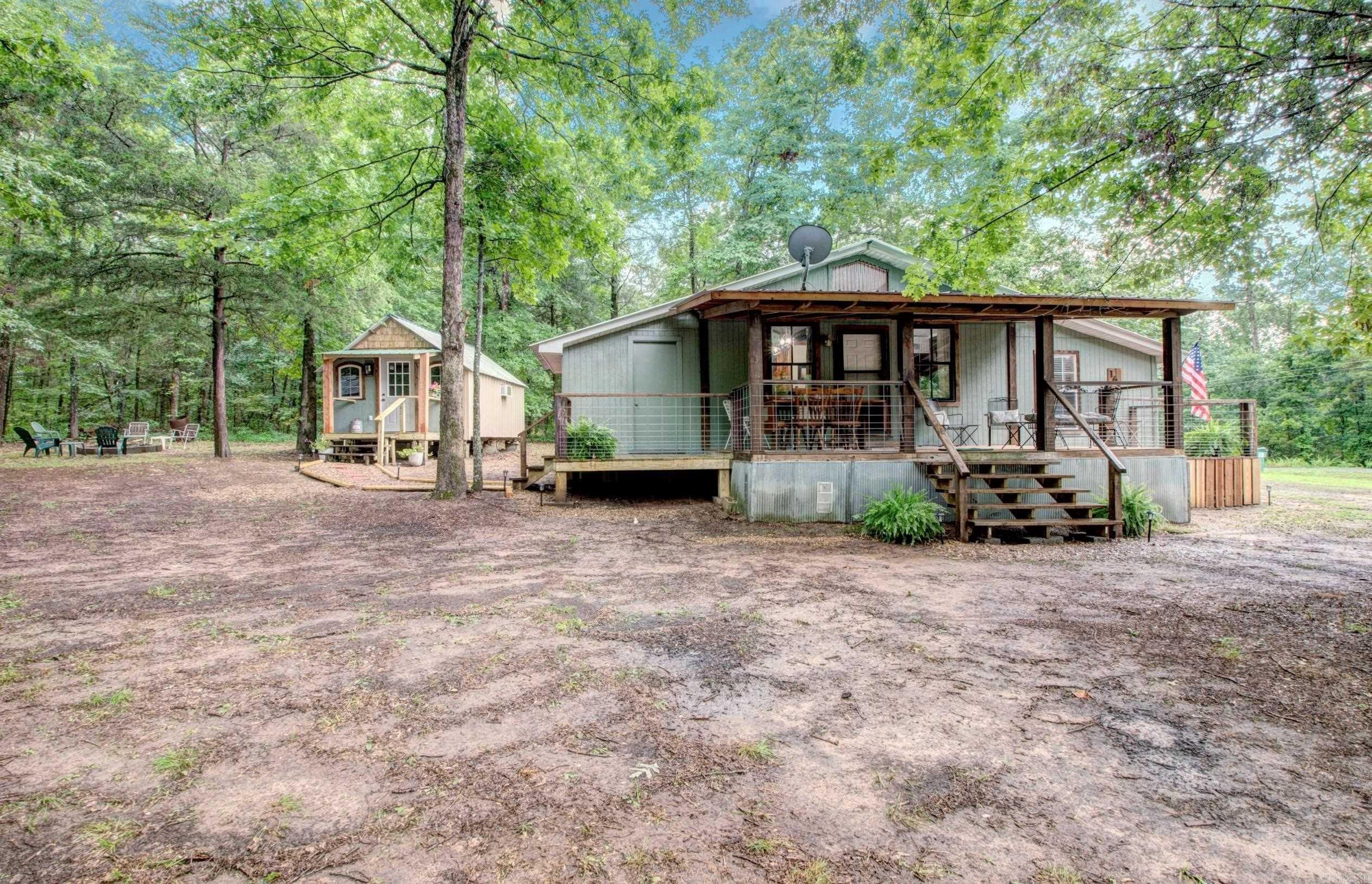 Charming Fully Remodeled Home Near Boat Launch on Nearly 2 Acres! This beautifully updated home is packed with character and move-in ready—sold fully furnished! The open-concept layout features a stunning kitchen and warm, inviting finishes throughout. Enjoy relaxing or entertaining on the expansive 240 sq ft covered front porch, perfect for soaking up the peaceful outdoor setting just minutes from the lake. The property also includes a separate guest space with a private walking path to its separate entrance to the laundry, and full bath—ideal for extended family, guests, or potential rental income. Whether you're looking for a full-time residence, vacation retreat, or short-term rental, this gem has it all. Don’t miss your chance to see it—call today for a private showing!