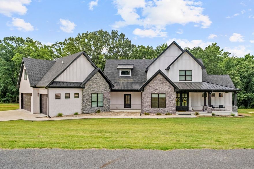 This stunning home checks all the boxes! It sits on a beautiful 2.64 acre lot in a gated subdivision with a fantastic view of the community fishing lake next door. The spacious living room features a vaulted ceiling with wood beams, stone accented gas log fireplace with a view of the lake. The gourmet kitchen is open to the living room. It has a huge island with a breakfast bar to seat the whole family plus a gas cooktop, double wall ovens, wall microwave, and a huge pantry with butcher block tops and a drink fridge. Kitchen fridge will stay. Elegant master suite downstairs with all the bells and whistles! Two laundry areas, one up and one down. The stackable laundry set will stay. Huge back covered back porch with wood ceiling. Bedrooms galore with 4 full bathrooms, really could be considered a 5 bedroom home. 3 car garage that has a 278 SF room that was built for dogs, currently used for storage. Great feature for dog owners! Built for energy efficiency with radiant roof barrier decking, spray foam insulation and tankless water heater. No carpet, LVP in living areas with ceramic tile in wet areas.  Come and see this fantastic home for yourself!