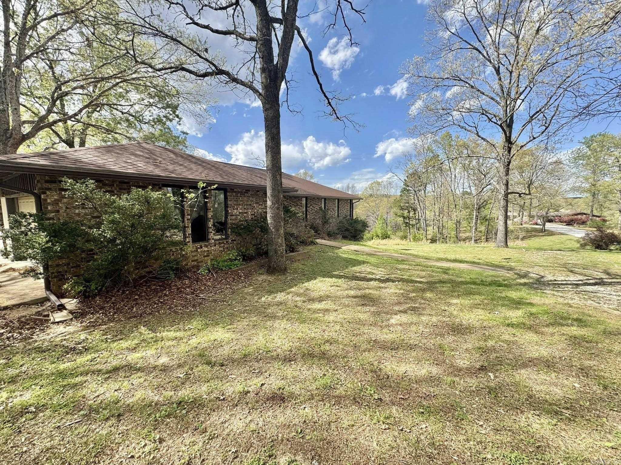 Spacious 5-bedroom, 3-bath home sitting on 3 beautiful acres just 8 miles from the downtown square! This property offers a full walk-out basement with endless potential, perfect for additional living space, a game room, or storage. The main level features a large open living room that flows into a roomy kitchen, plus a separate dining area and utility room for convenience. 3 bedrooms and 2 baths are on the main floor with 2 bedrooms and 1 full bath in the basement. New roof and new gutters within the last 3 months. Step out onto the oversized back deck and enjoy peaceful views of nature and the surrounding land. With a little TLC and updating, this home could truly shine—ideal for someone ready to add their personal touch in a great location!