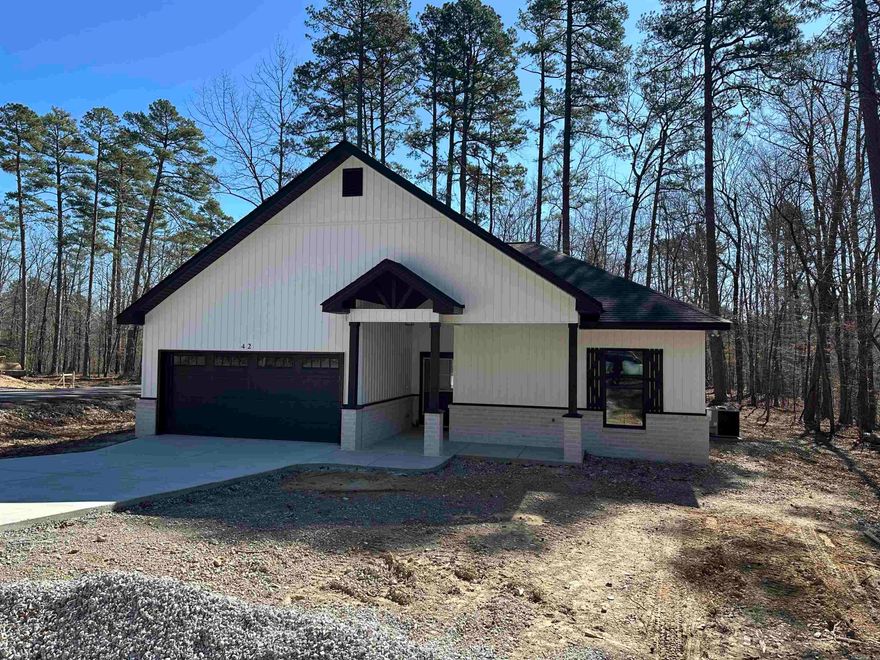New construction by Walter Alan Homes located on a quiet cul de sac and designed with quality finishes throughout. This open floor plan has a separate dining area and a spacious living room featuring an electric fireplace. The kitchen includes quartz countertops that continue throughout the home. The primary bath features a beautifully finished tile shower and modern touches, with additional tile shower in secondary bath. Enjoy the covered patio, perfect for nature watching and relaxing in a peaceful setting. One year builder warranty included. Taxes reflect lot only.