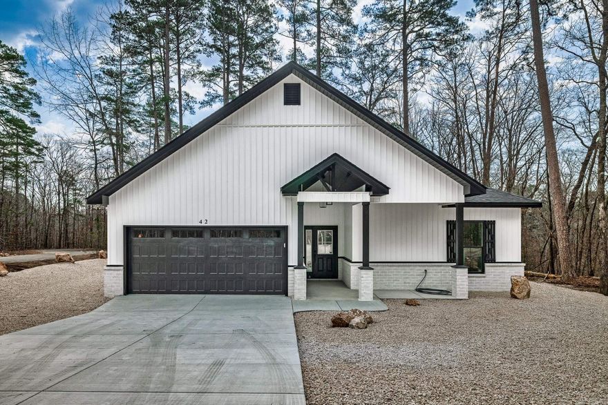 New construction by Walter Alan Homes located on a quiet cul de sac and designed with quality finishes throughout. This open floor plan has a separate dining area and a spacious living room featuring an electric fireplace. The kitchen includes quartz countertops that continue throughout the home. The primary bath features a beautifully finished tile shower and modern touches, with additional tile shower in secondary bath. Enjoy the covered patio, perfect for nature watching and relaxing in a peaceful setting. One year builder warranty included. Taxes reflect lot only.