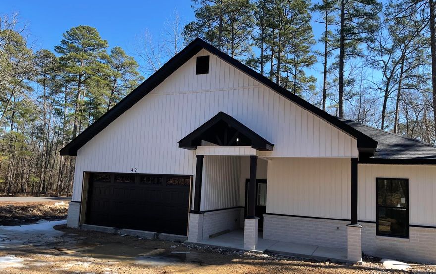 New construction by Walter Alan Homes located on a quiet cul de sac and designed with quality finishes throughout. This open floor plan has a separate dining area and a spacious living room featuring an electric fireplace. The kitchen includes quartz countertops that continue throughout the home. The primary bath features a beautifully finished tile shower and modern touches, with additional tile shower in secondary bath. Enjoy the covered patio, perfect for nature watching and relaxing in a peaceful setting. One year builder warranty included. Taxes reflect lot only.