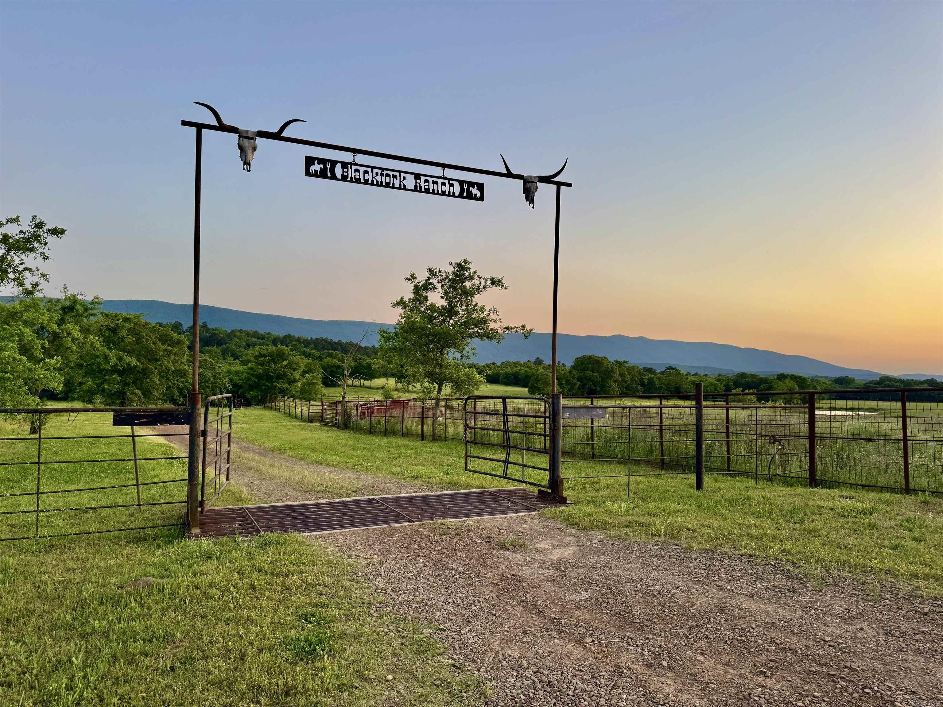 This extraordinary property, nestled between two majestic mountain ranges, offers a diverse array of uses. Itās an outdoorsmanās dream, providing exceptional hunting and fishing opportunities, alongside its potential as a superb cattle and country ranch. The breathtaking beauty of this ranch is hard to capture in pictures or words, making it a truly unique and versatile investment. The ranch offers over 400 acres of sprawling pasture with over 200 feet of elevation, this ranch boasts million-dollar views. The pastureland is fully fenced and has previously been utilized for grazing and hay production. Multiple roads, trails, and gated entry points facilitate the rotation of cattle and access to different areas of the ranch. Adjacent to the Black Mountain Wilderness area, the property offers incredible hunting opportunities, including deer, bear, turkey, and hog hunting. Notable deer have been harvested here, adding to its appeal for hunting enthusiasts. Water is plentiful on this property, with the Black Fork River meandering through, accompanied by Price and Briery Creeks.