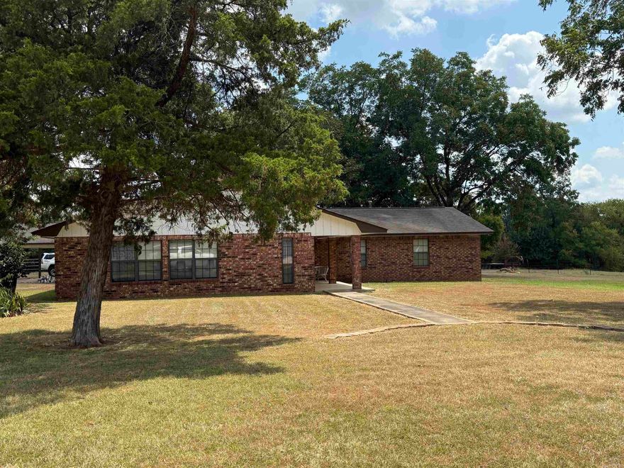 Large home west of Nashville, situated on approx 4.75 acres.  Property offers a brick home with approx 2,635 sq ft of living space, 40x40 shop building with roll up doors, concrete floor, electricity, feed/hay room and two horse stalls.  Home has 4 bedrooms and 2 fulls baths, kitchen with large dining area, family room with wood burning stove, spacious master bedroom offers built-in dresser/wardrobe, walk in closet, master bath with double vanity, walk-in shower and extra storage.  Large laundry, double garage, 2 hot water heaters, one gas/one electric, CH/CA, storage building and patio.  Contact our office for more details.