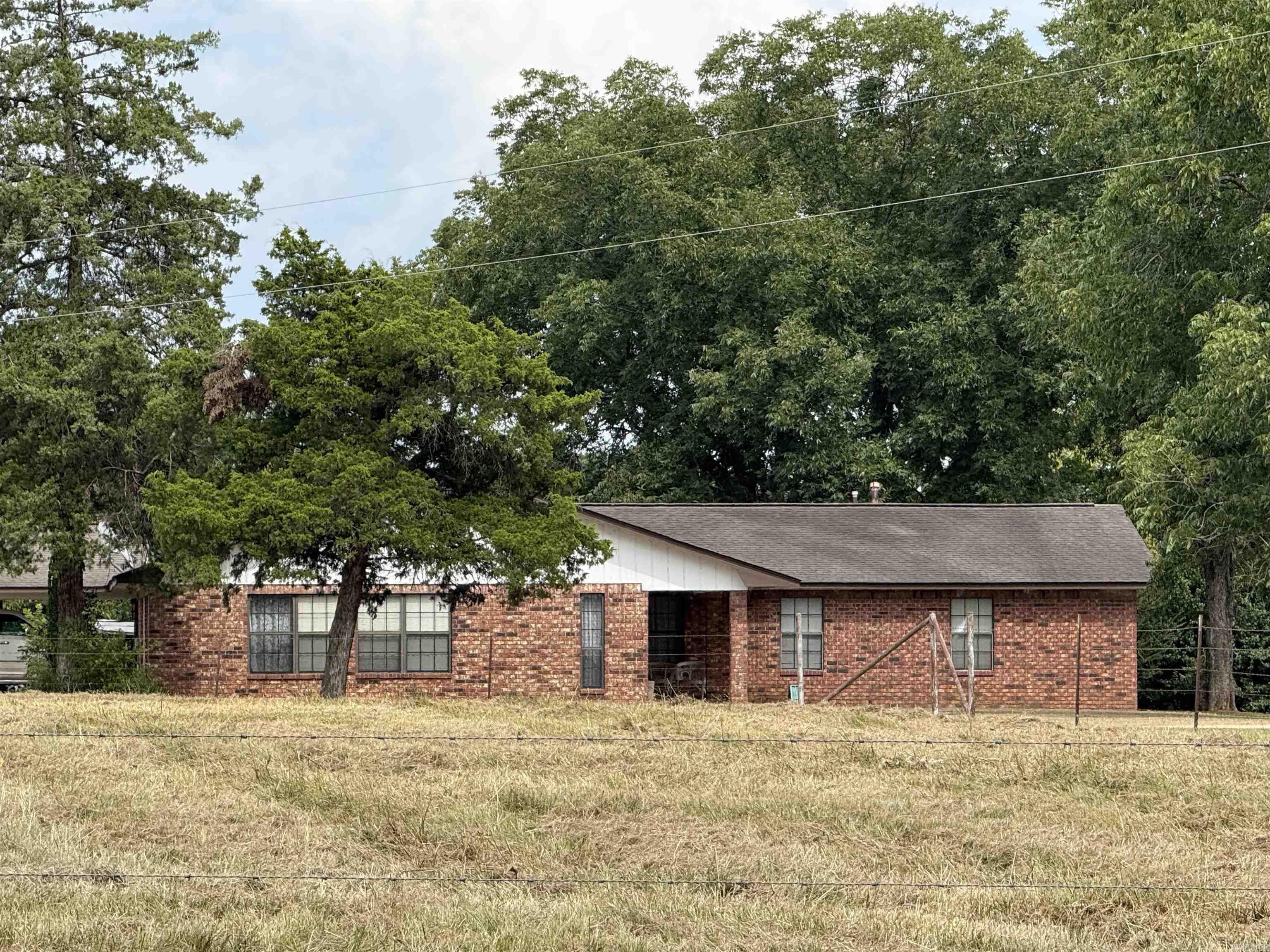 Large home west of Nashville, situated on approx 4.75 acres. Property offers a brick home with approx 2,635 sq ft of living space, 40x40 shop building with roll up doors, concrete floor, electricity, feed/hay room and two horse stalls. Home has 4 bedrooms and 2 fulls baths, kitchen with large dining area, family room with wood burning stove, spacious master bedroom offers built-in dresser/wardrobe, walk in closet, master bath with double vanity, walk-in shower and extra storage. Large laundry, double garage, 2 hot water heaters, one gas/one electric, CH/CA, storage building and patio. Contact our office for more details.