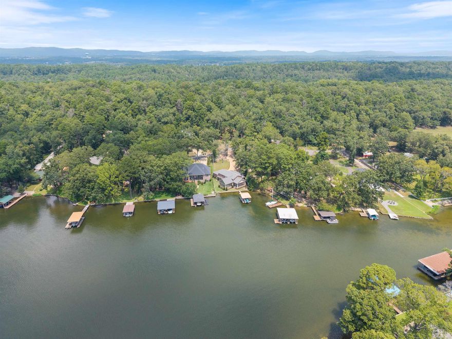 Rare opportunity on Lake Hamilton with 135 feet of frontage, a protective seawall, and incredible views of Mt. Riante and sunsets. Located in a highly desirable area near Garvan Woodland Gardens, Electric Island, and the Fish Hatchery. Features include a 2 stall boat dock with swim platform, a 30 foot fishing pier, private boat ramp, and private drive. City water and sewer are connected. The perfect setting for your dream home or investment in one of Hot Springs’ most sought after lakefront communities.