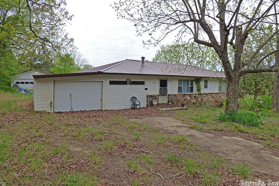 House with 15 Acres! Located in a very private area this house has over 1600 square feet of living space with two (2) bedrooms, a full and a three-quarter bath, family room with a wood burning fireplace, living room, kitchen, central heat & air. Detached shop/garage, metal roof, and concrete siding. Sitting at the end of the road, 10 acres with the house and 5 acres across the road of hay field, woods and a pond makes this property very private.