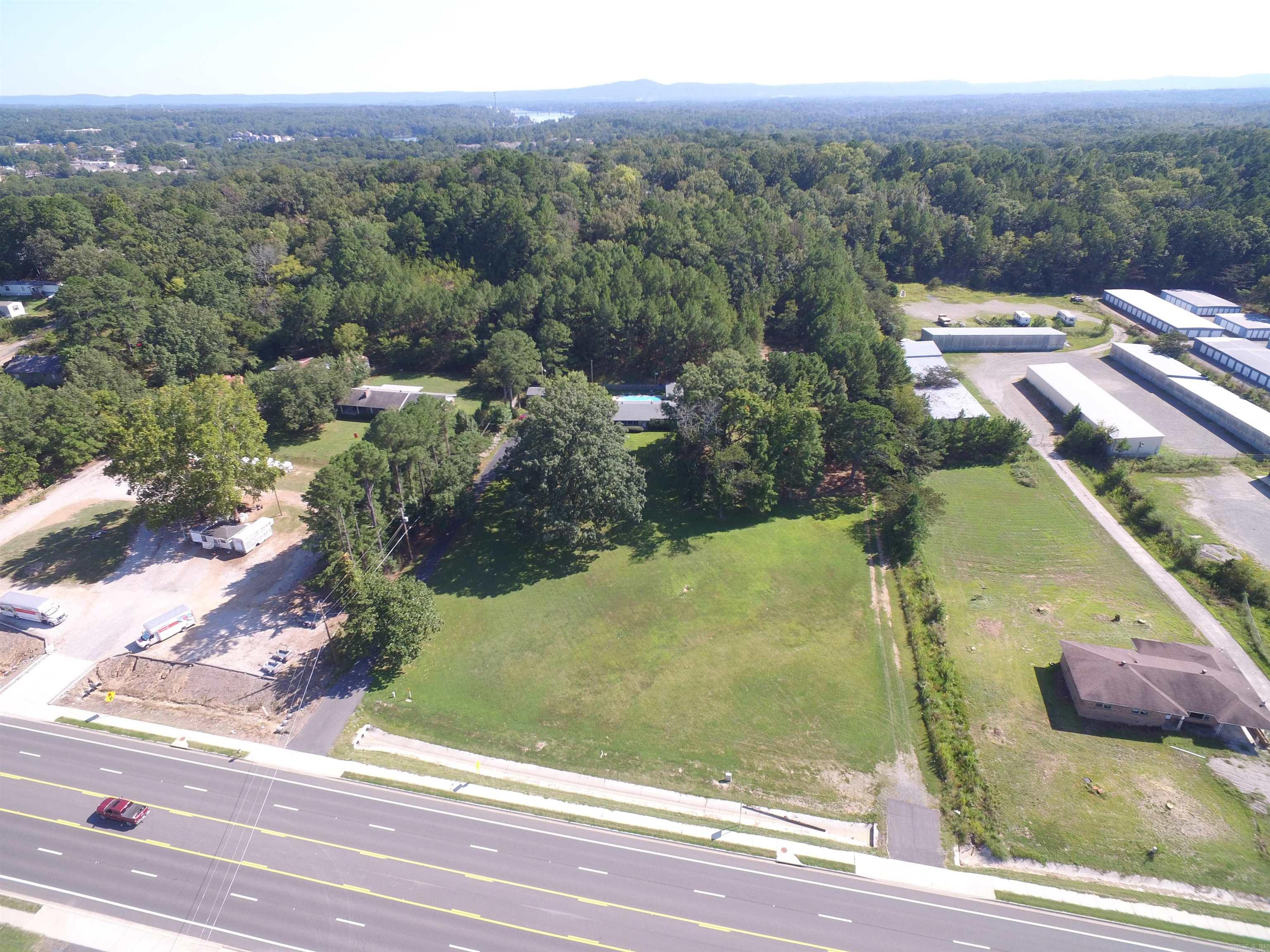 INVESTMENT COMMERCIAL PROPERTY FOR: CONVENIANT STORE, GAS STATION, RETAIL, MINI STORAGES, DEVELOPERS, VISONAIRES- TAKE NOTICE-- THIS PROPERTY OFFERS MULTIPLE OPPORTUNITIES --HIGHWAY 270 WEST WITH 5 LANES AND 4.79 ACRES (MOL) --APPROXIMATELY 278 FEET OF HIGHWAY FRONTAGE WITH 2 PAVED ENTRANCES ON EACH CORNER. BUILD YOUR DREAM DEVELOPEMENT ON THE FLAT FRONT AVREAGE (APPROXIMATELY 1.5-2.0 ACRES) AND KEEP/RENT HOME & SHOP (20 X 30) WITH POOL & GUEST/ SHE SHED OR SELL IT AND HAVE YOUR INVESTMENT COST REDUCED. MAJOR UTLITIES AT THE HIGHWAY AND HOME. HIGH TRAFFIC COUNT & VISABILITY--OVER 12,000 CARS A DAY PER AR-DOT