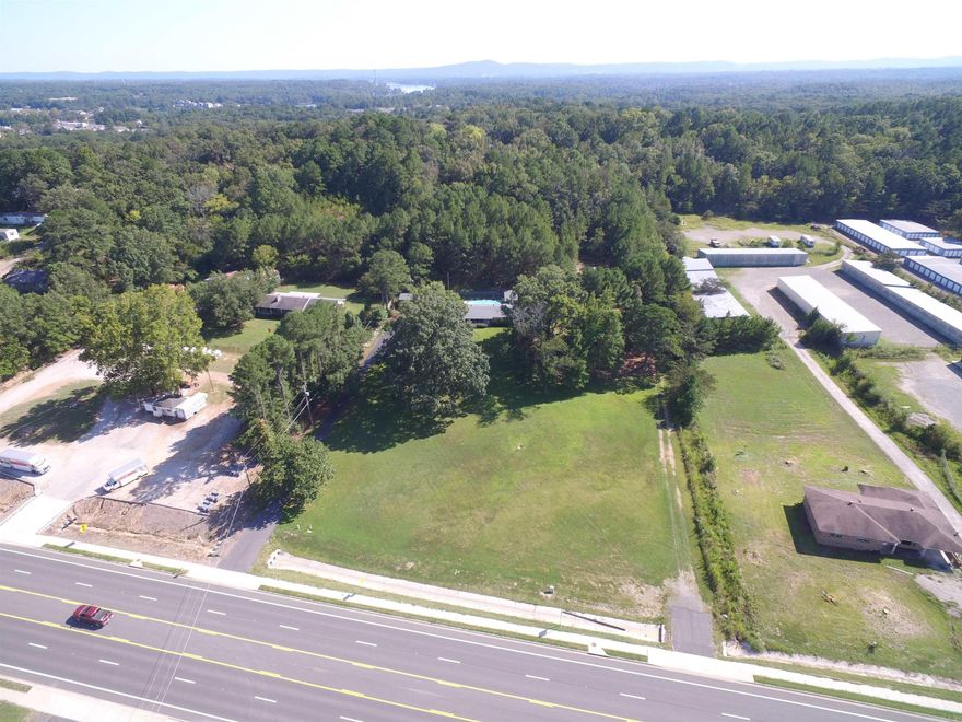 INVESTMENT COMMERCIAL PROPERTY FOR:  CONVENIANT STORE, GAS STATION, RETAIL, MINI STORAGES, DEVELOPERS, VISONAIRES- TAKE NOTICE-- THIS PROPERTY OFFERS MULTIPLE OPPORTUNITIES --HIGHWAY 270 WEST WITH 5 LANES AND 4.79 ACRES (MOL) --APPROXIMATELY 278 FEET OF HIGHWAY FRONTAGE WITH 2 PAVED ENTRANCES ON EACH CORNER.  BUILD YOUR DREAM DEVELOPEMENT ON THE FLAT FRONT AVREAGE (APPROXIMATELY 1.5-2.0 ACRES)  AND KEEP/RENT HOME & SHOP (20 X 30) WITH POOL & GUEST/ SHE SHED OR SELL IT AND HAVE YOUR INVESTMENT COST REDUCED.  MAJOR UTLITIES AT THE HIGHWAY AND HOME. HIGH TRAFFIC COUNT & VISABILITY--OVER 12,000 CARS A DAY PER AR-DOT