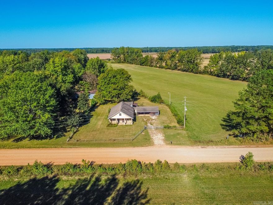 Welcome to Market 1685 County Road 757 of Jonesboro Arkansas. Nestled on 3 +/- beautiful green acres is a charming farmhouse with attached two car carport, floored & wired workshop, detached storage building, and barn.  Built strong in the 1930s, the exterior of the house is wrapped in sturdy concrete block with vinyl addition and is accented by a front porch made for sitting and watching wildlife. The interior contains 2 bedrooms on the main, 2 bedrooms on the 2nd floor, full bath with walk-in shower, kitchen, dining area, living room, and workshop/laundry room area. The grounds hold mature shade trees, creek, fencing, and gate.  Utilities include: CWL water, Craighead Electric, septic, and Craft Propane. If country living is calling your name, then this is the property you've been waiting on to hit the Market. Outside the city, yet close to Jonesboro city limits, Brookland, and Bono. Call today to schedule your tour and make this farmhouse your home.  *Additional acreage available.