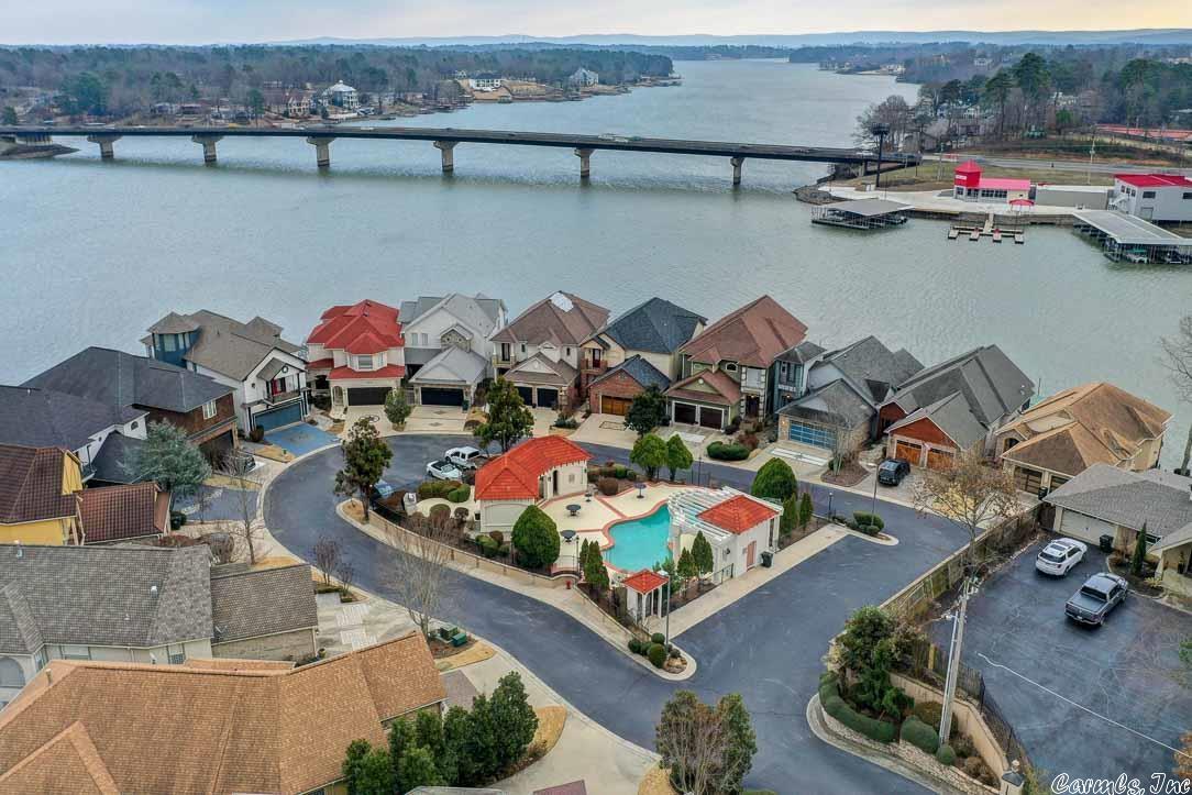 You will be stunned by the breath taking view of Lake Hamilton the moment you enter this one of a kind tri-level home. The main level consists of a gourmet kitchen and is open to the living & dining area. Upstairs features a private master retreat with spa-like bath. Downstairs contains a second living area, 2 guest bedrooms, 2 full baths and a private covered lakeside patio just steps away from the boardwalk and boat dock.