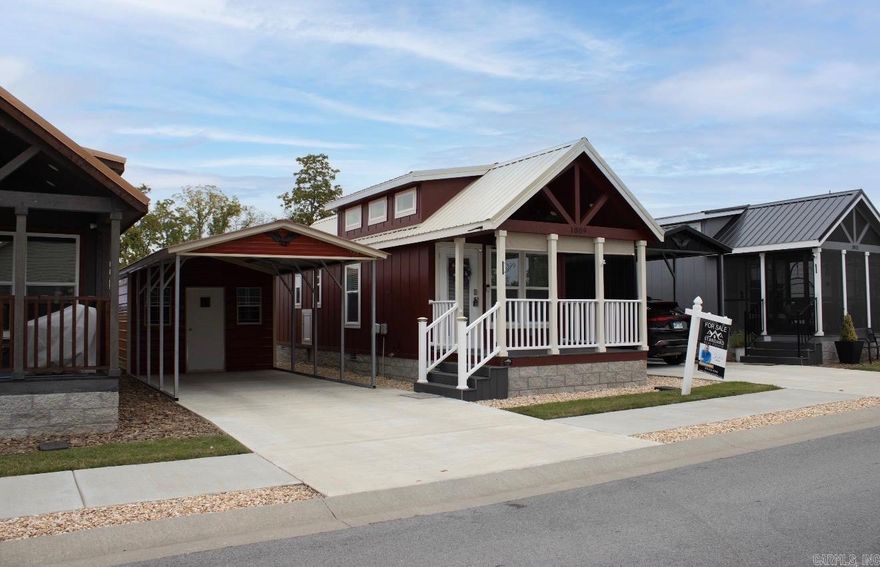 *Seller offering 4 Months of HOA fees paid with full-price offer!* Welcome to your charming 2023-built tiny home—a perfect blend of style, efficiency, and convenience in a peaceful Rogers community. This single-level, all-electric 1-bedroom, 1-bath home offers low-maintenance, low-cost living with quality upgrades throughout.  Step onto the inviting front porch and into a thoughtfully designed interior featuring durable LVP flooring, window blinds, ceiling fans, double-insulated walls, and two energy-efficient mini-splits for year-round comfort. The kitchen shines with abundant storage and full-size stainless steel appliances, while the bedroom boasts dual closets with a built-in dresser for exceptional organization.  All appliances convey—including washer, dryer, and refrigerator—making this truly move-in ready. Additional highlights include a metal roof, detached 350 sq. ft. storage building, and a metal carport.  Enjoy the unbeatable location—minutes from Downtown Rogers, shopping, dining, parks, schools, the greenway trail, hospital, and fire station. Must be owner-occupied; rentals not permitted.